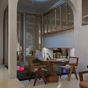 Minimalist V-leg wooden armchairs and solid wood round coffee table in zen space