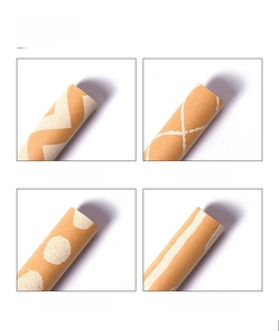 Detail showing four white printed patterns on kraft paper rolls for gift wrapping