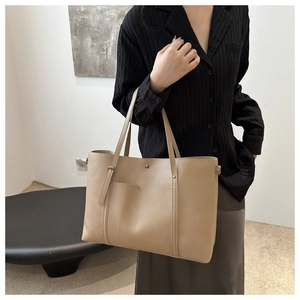 Detail showing beige PU leather shoulder bag with spacious front pocket and adjustable strap