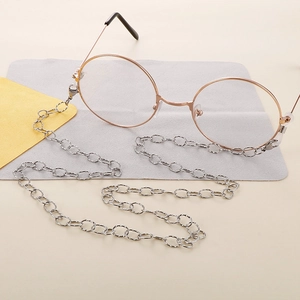Close-up of silver stainless steel O-chain eyewear strap with elegant rose gold glasses