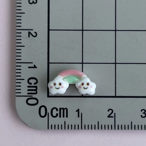 Close-up of mini rainbow cloud resin accessory with dimensions on a ruler grid