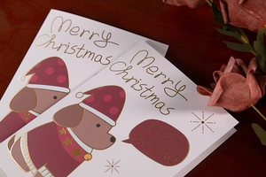 Detail of high-end Christmas cards with gold foil stamping and cute dog pattern