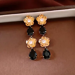 Boucles d'oreilles fleurs plaquées or 18K avec gemmes noires et détails zircon