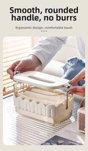Close-up of modern wavy cream tissue box with transparent body and silver spherical handle