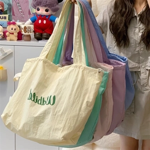 Group display of colorful canvas tote bags in soft macaron shades and natural textures