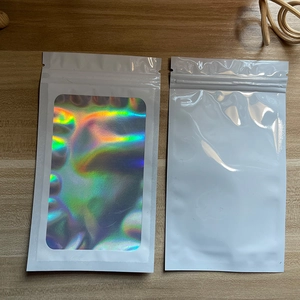 Close-up of white holographic laser resealable bags with window on a wooden surface