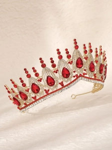 Detail of luxury golden bridal crown with red teardrop gemstones and white crystals