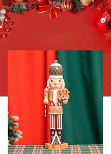 Detail of gingerbread chef nutcracker holding a candy cane and cookie tray for Christmas