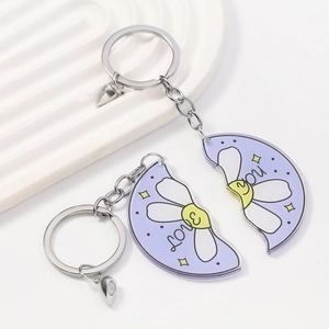 Detail of magnetic couple daisy keychains in purple acrylic with love you text
