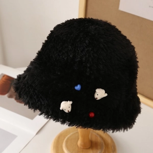 Chic black plush bucket hat with cute bear and heart accents for winter warmth