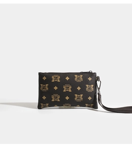 Detail of lychee textured PU leather wallet with gold patterns and wrist strap
