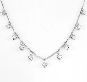 Detailed macro view of silver stainless steel necklace with multiple 3D heart pendants