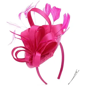 Detail view of rose pink fascinator with feathers, satin ribbons and hair clip base