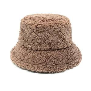 Close-up of deep brown teddy fleece bucket hat texture and soft lamb wool fabric