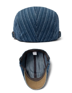 Detail view of denim beret featuring 100% cotton lining and adjustable side metal buckle