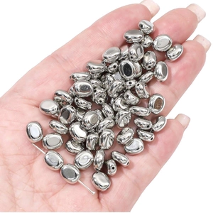 Close-up of shiny silver star and pebble shaped CCB spacer beads for DIY jewelry making