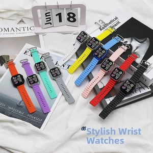 Flat lay of colorful LED electronic watches with ocean style silicone straps on white fabric