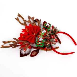 Close-up of Christmas reindeer antlers headband with HO HO HO sign and red bow detail