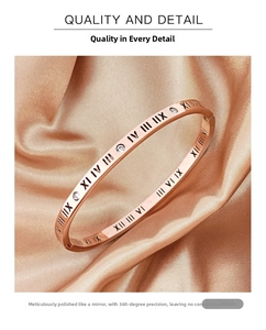Detail of rose gold bangle with roman numerals and diamonds on silk background