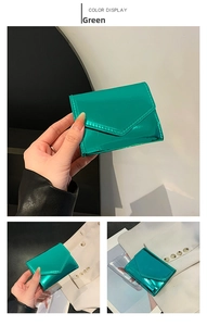 Detail view of a green metallic envelope wallet with compact fold-over flap design