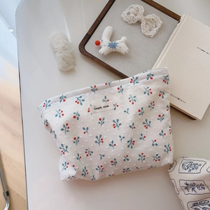 Minimalist cotton makeup bag with red cherry prints and a secure zipper closure
