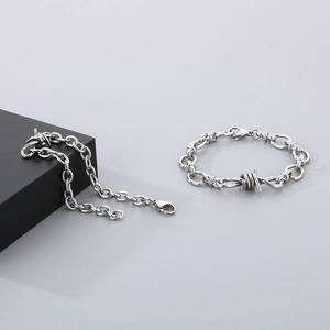 Macro detail of silver thorn knot bracelet with industrial lobster clasp closure