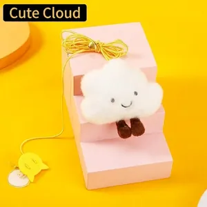 Close-up of plush cloud cat toy with smiley embroidery and hanging elastic yellow rope