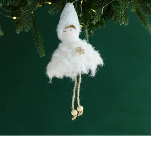 Detail of white plush Christmas angel ornament with golden snowflake and wooden beads
