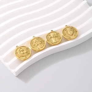 Close-up of gold titanium steel pendants with moon, star, tree of life, and heart patterns