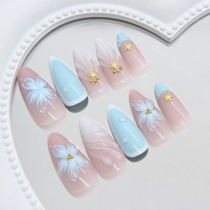 Blue ocean style press-on nails with 3D starfish and flower patterns in a heart tray
