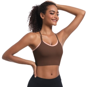 Detail of cross-strap back and brown-pink contrast piping on women's sports bra
