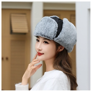 Detail of gray winter bomber hat with windproof fabric and soft faux fur earflaps