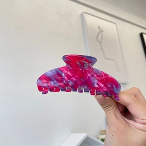 Pink marble acetate hair claw clip with glossy finish for elegant hairstyling