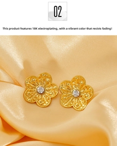 Detailed close-up of 18K gold plated flower stud earrings with sparkling crystal accents