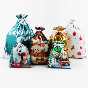 Detailed view of assorted Christmas drawstring gift bags with reindeer and Santa patterns