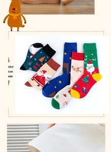 Macro view of five pairs of Christmas cotton socks with festive cartoon patterns