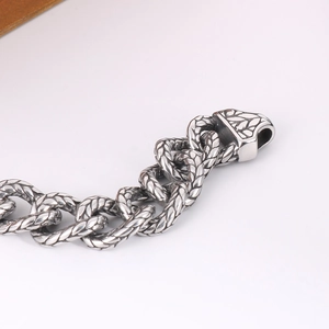 Macro shot of vintage silver titanium steel chain with industrial braided pattern