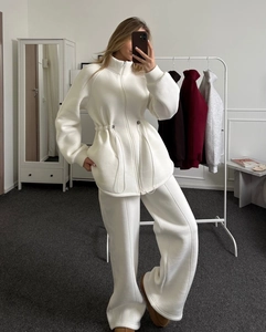 Detail of white fleece two-piece sportswear set with zipper cardigan and drawstring waist