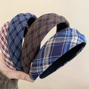 Detail view of thickened plaid headbands in various colors with retro fabric texture