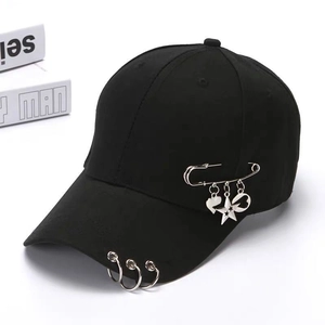 Fashionable black baseball cap with silver metal rings and pin heart star charms