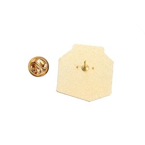 Detail of the golden hexagon brooch back with textured finish and butterfly clasp