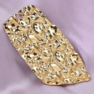 Detailed view of gold irregular hammered 304 stainless steel heart-shaped pendant