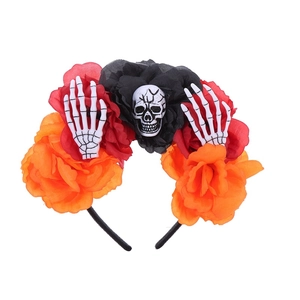 Detail of Halloween headband with orange roses, skull and skeletal hand accents