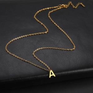 Detailed view of a gold-plated stainless steel letter A pendant on a fine O-chain