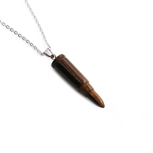 Punk style bullet pendant necklace with tiger eye stone and silver chain on white background