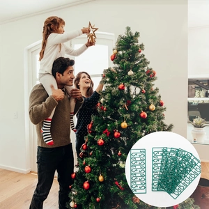 Close-up of green S-shaped plastic hooks for hanging Christmas tree ball ornaments