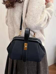 Chic black shell-shaped crossbody bag with vintage gold metal clasp and top handle