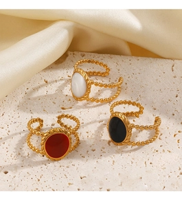 Detailed view of three 18K gold-plated oval rings with colorful enamel on stone