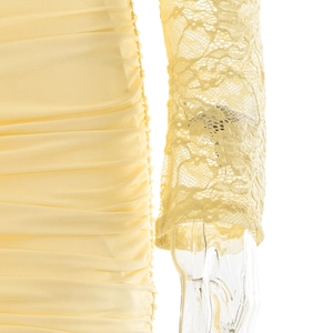 Detail of yellow bodycon dress showing side ruching and delicate lace long sleeves