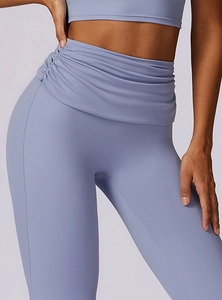 Detailed close-up of high-waisted lavender yoga pants with ruched tummy control design